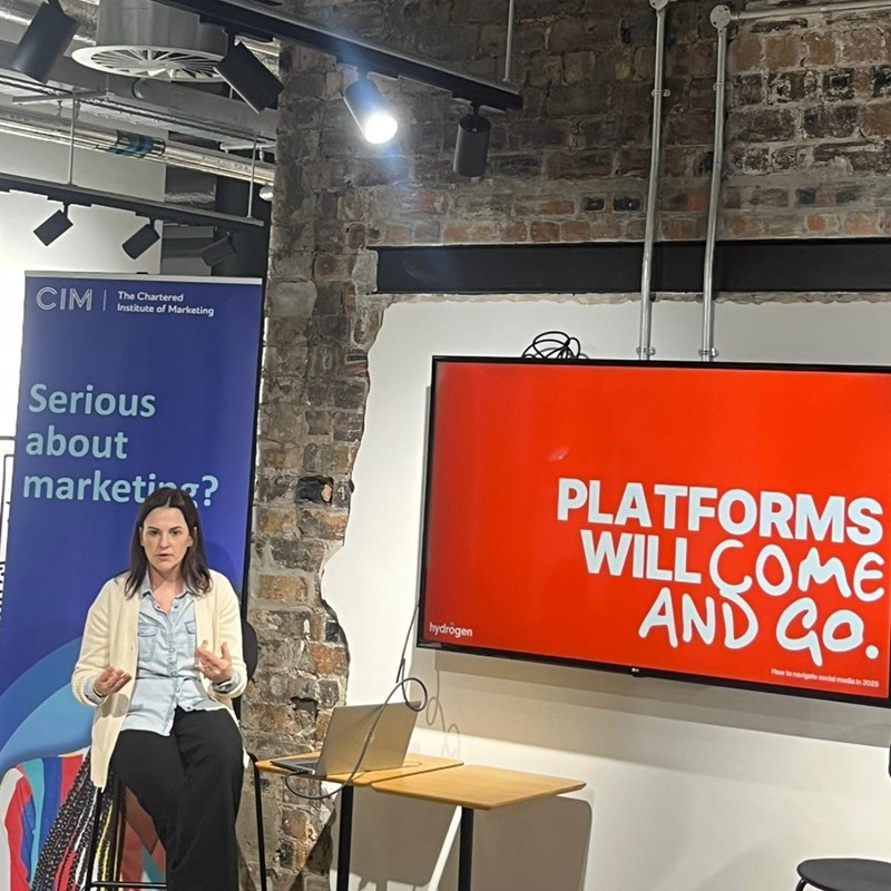 Nicky gestures in front of a giant TV that reads "platforms will come and go"