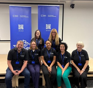 7 members of CIM North West Committee members on stage